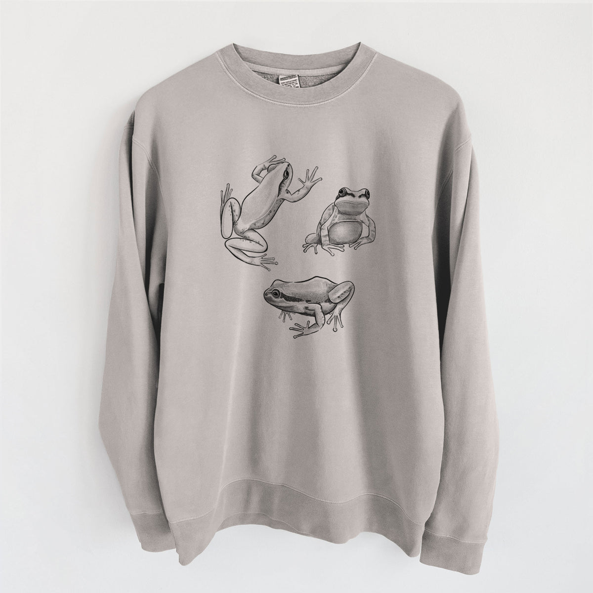 Cement grey pigment dyed crewneck sweatshirt laid flat, printed with a black ink illustration of three Pacific tree frogs in different poses.