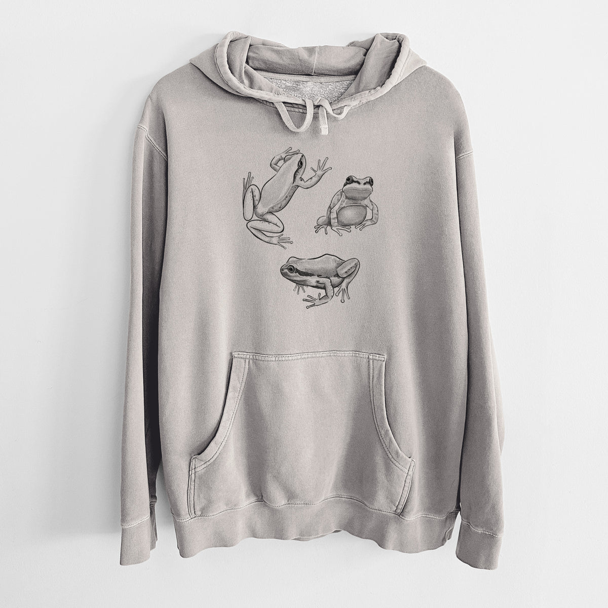 Cement grey pigment dyed hoodie laid flat, printed with a black ink illustration of three Pacific tree frogs in different poses.