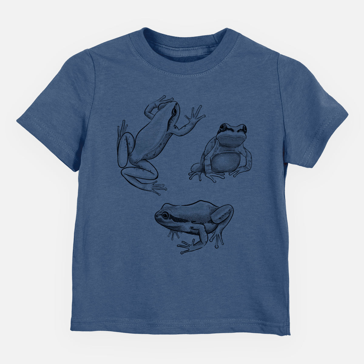 Indigo blue toddler t-shirt laid flat, printed with a black ink illustration of three Pacific tree frogs in different poses.