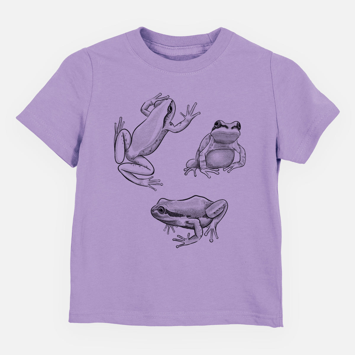 Lavender toddler t-shirt laid flat, printed with a black ink illustration of three Pacific tree frogs in different poses.