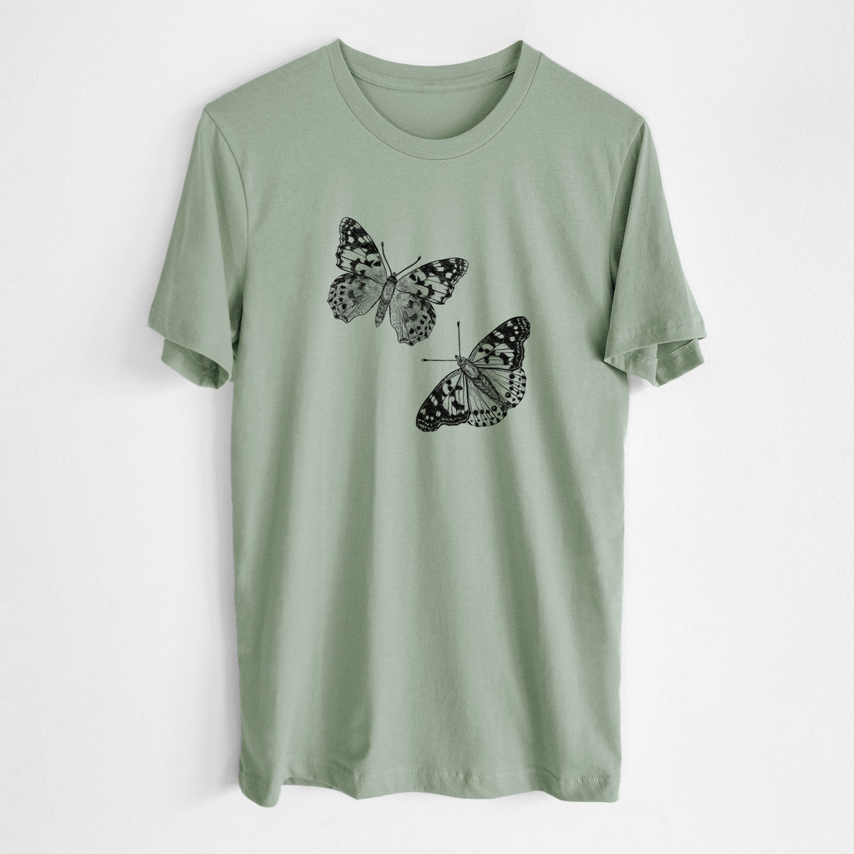 Sage green lightweight cotton t-shirt laid flat, printed with a detailed black ink illustration of two painted lady butterflies.