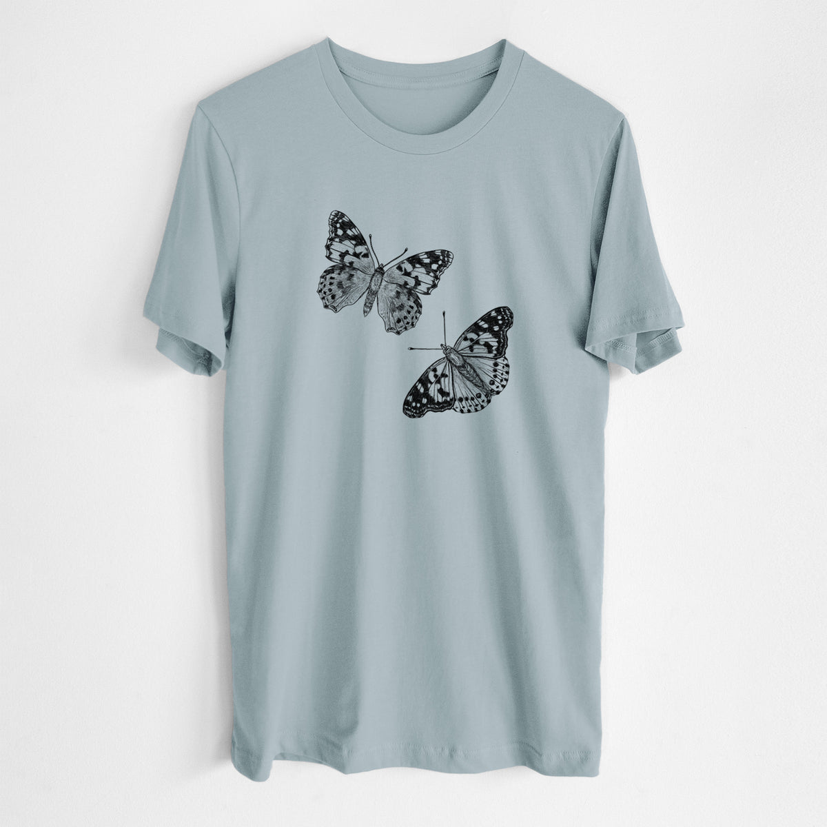 Vintage denim lightweight cotton t-shirt laid flat, printed with a detailed black ink illustration of two painted lady butterflies.