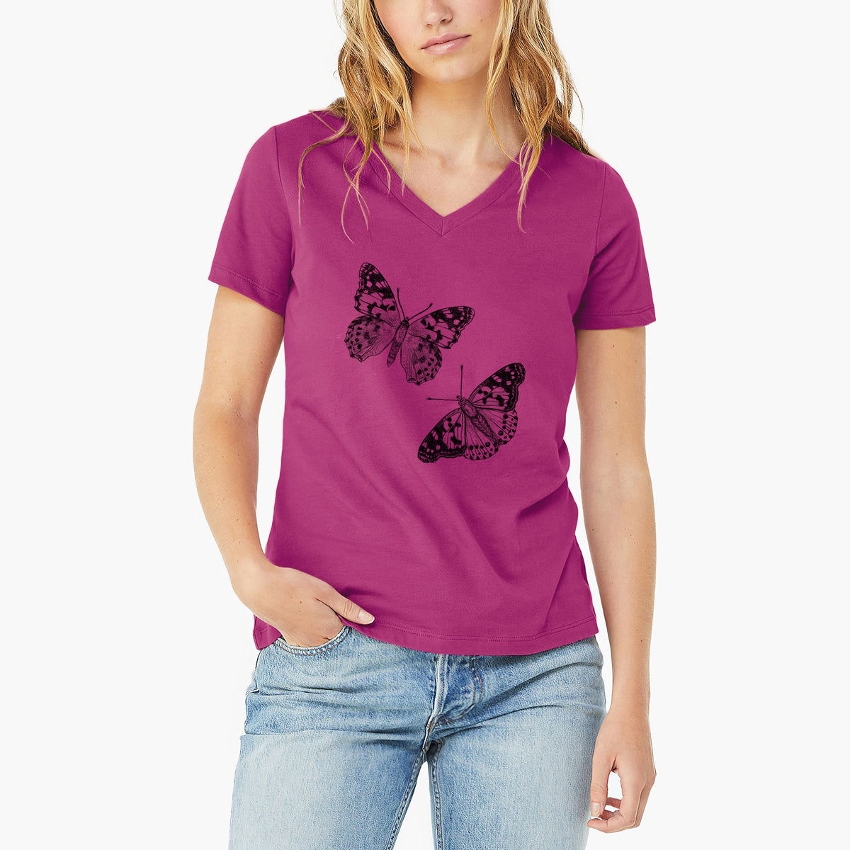 Woman wearing a berry pink women's relaxed fit cotton V-neck t-shirt printed with a detailed black ink illustration of two painted lady butterflies.