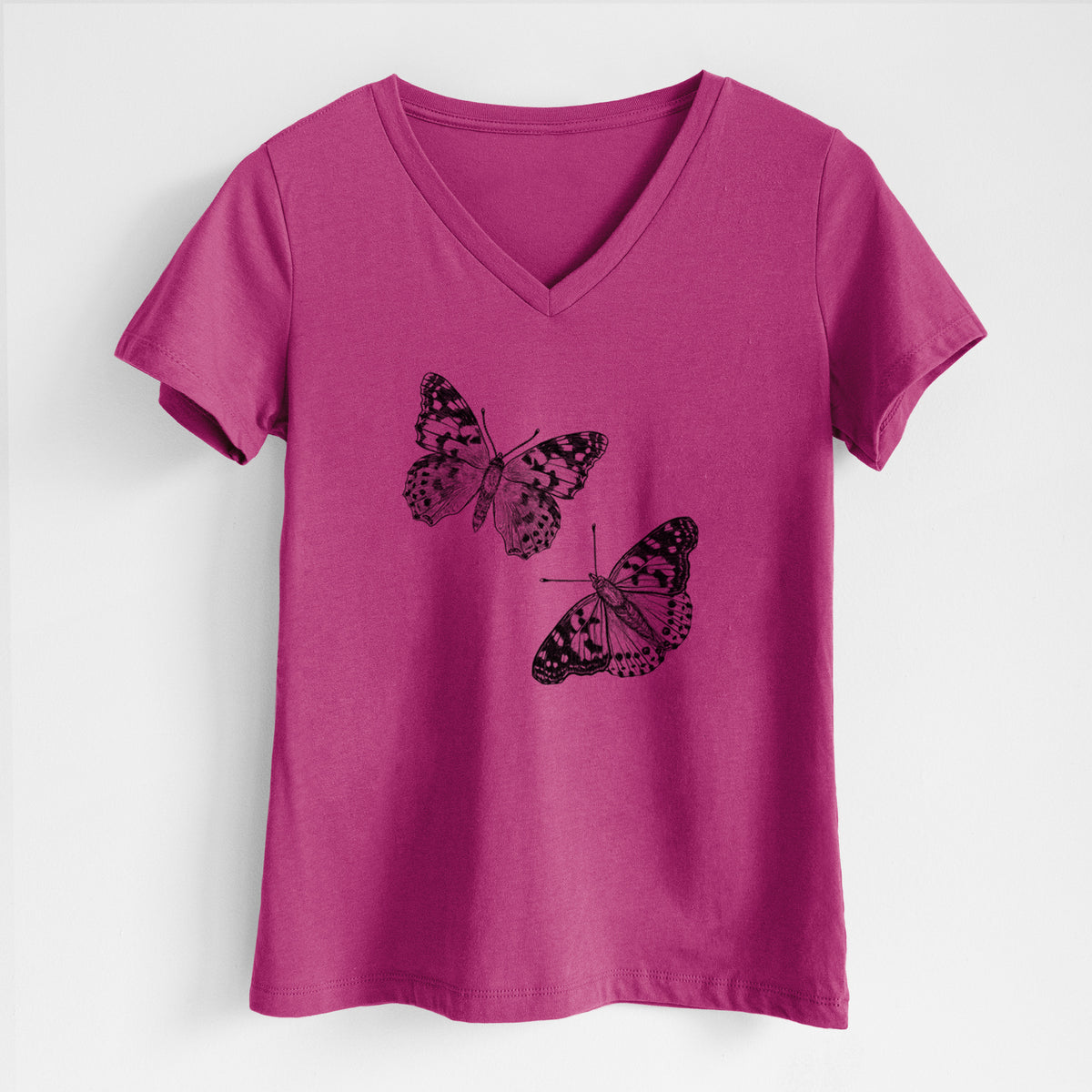 Berry pink women's relaxed fit cotton V-neck t-shirt laid flat, printed with a detailed black ink illustration of two painted lady butterflies.