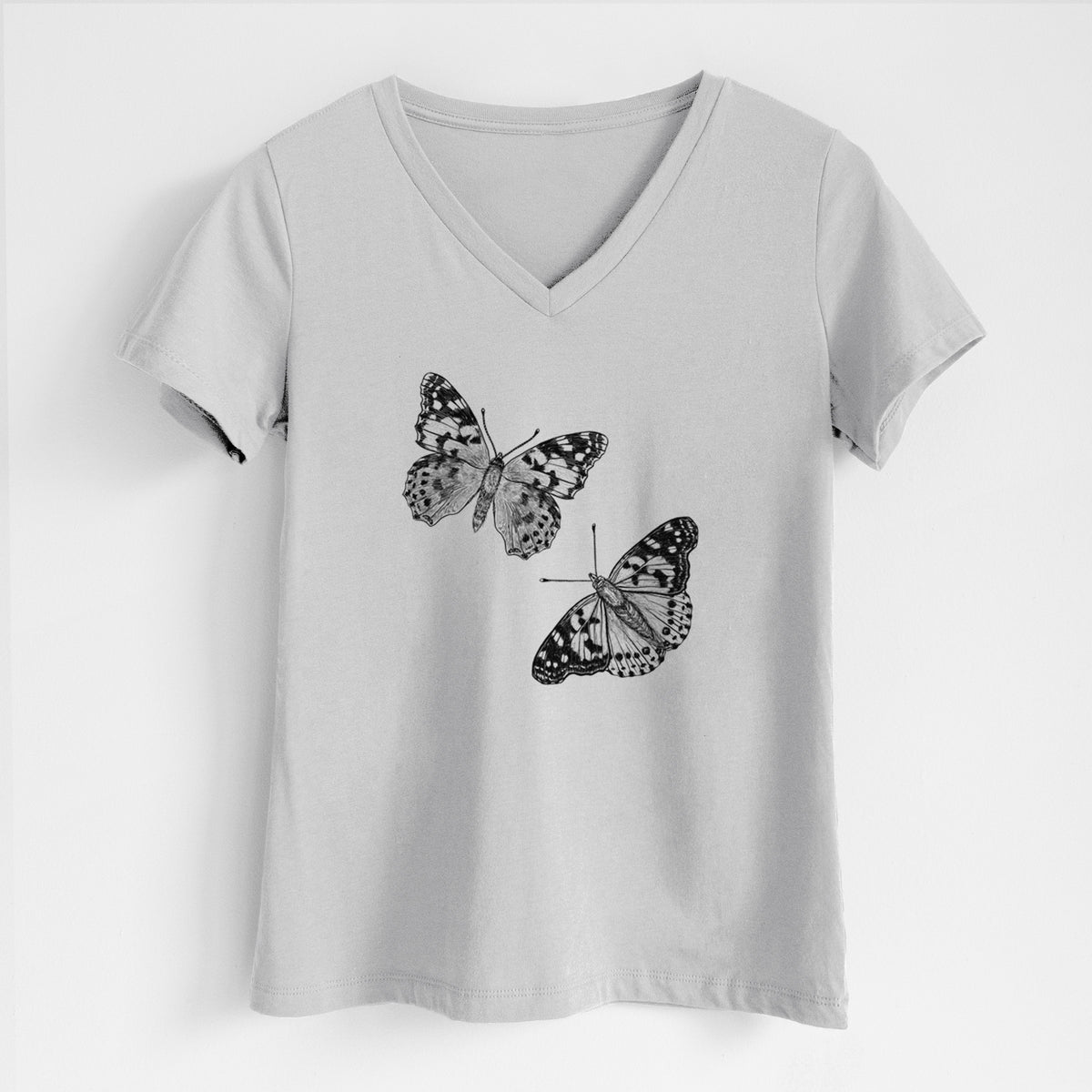 Lunar grey women's relaxed fit cotton V-neck t-shirt laid flat, printed with a detailed black ink illustration of two painted lady butterflies.