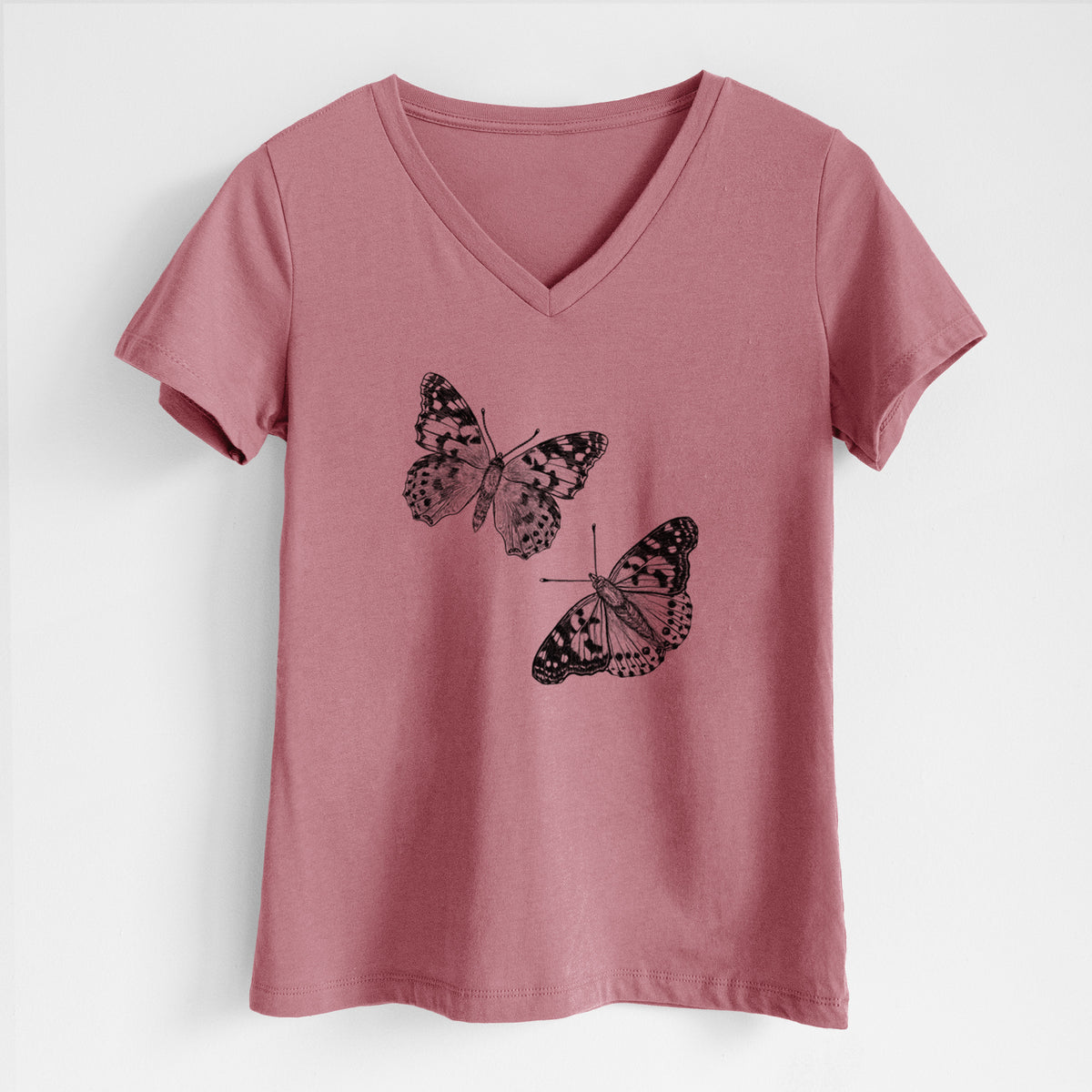 Mauve pink women's relaxed fit cotton V-neck t-shirt laid flat, printed with a detailed black ink illustration of two painted lady butterflies.