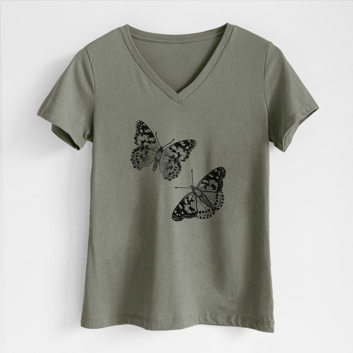 Military green women's relaxed fit cotton V-neck t-shirt laid flat, printed with a detailed black ink illustration of two painted lady butterflies.