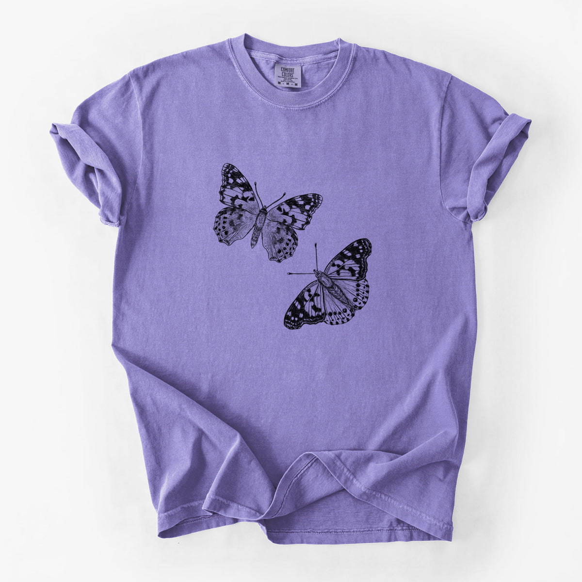Violet purple Comfort Colors t-shirt laid flat, printed with a detailed black ink illustration of two painted lady butterflies.