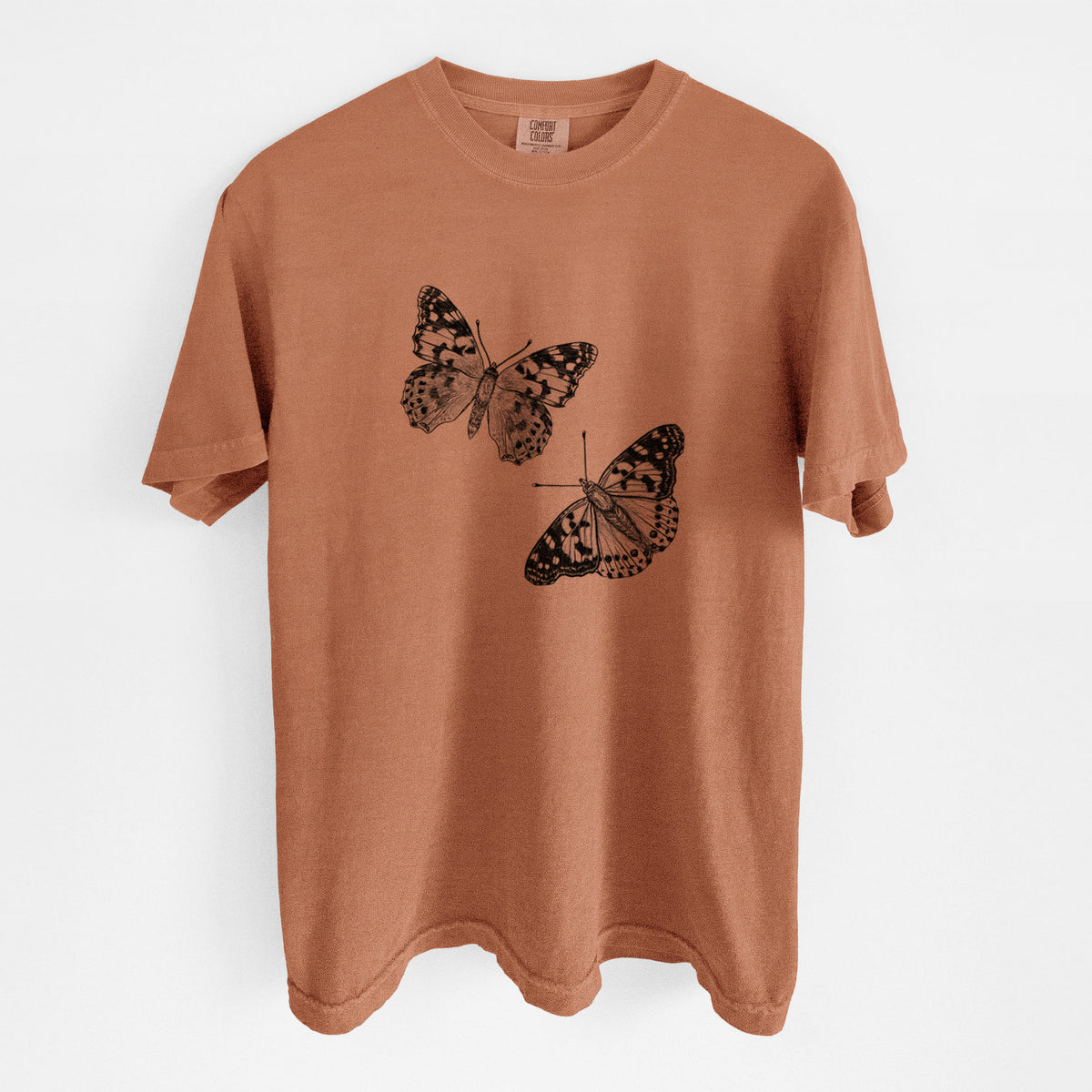 Yam burnt orange Comfort Colors t-shirt laid flat, printed with a detailed black ink illustration of two painted lady butterflies.