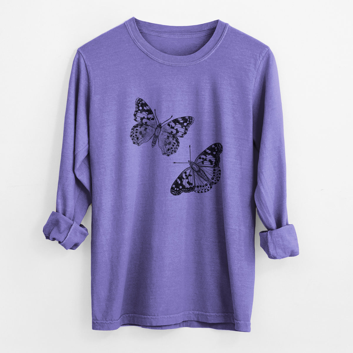 Violet purple Comfort Colors long sleeve shirt laid flat with the cuffs rolled, printed with a detailed black ink illustration of two painted lady butterflies.