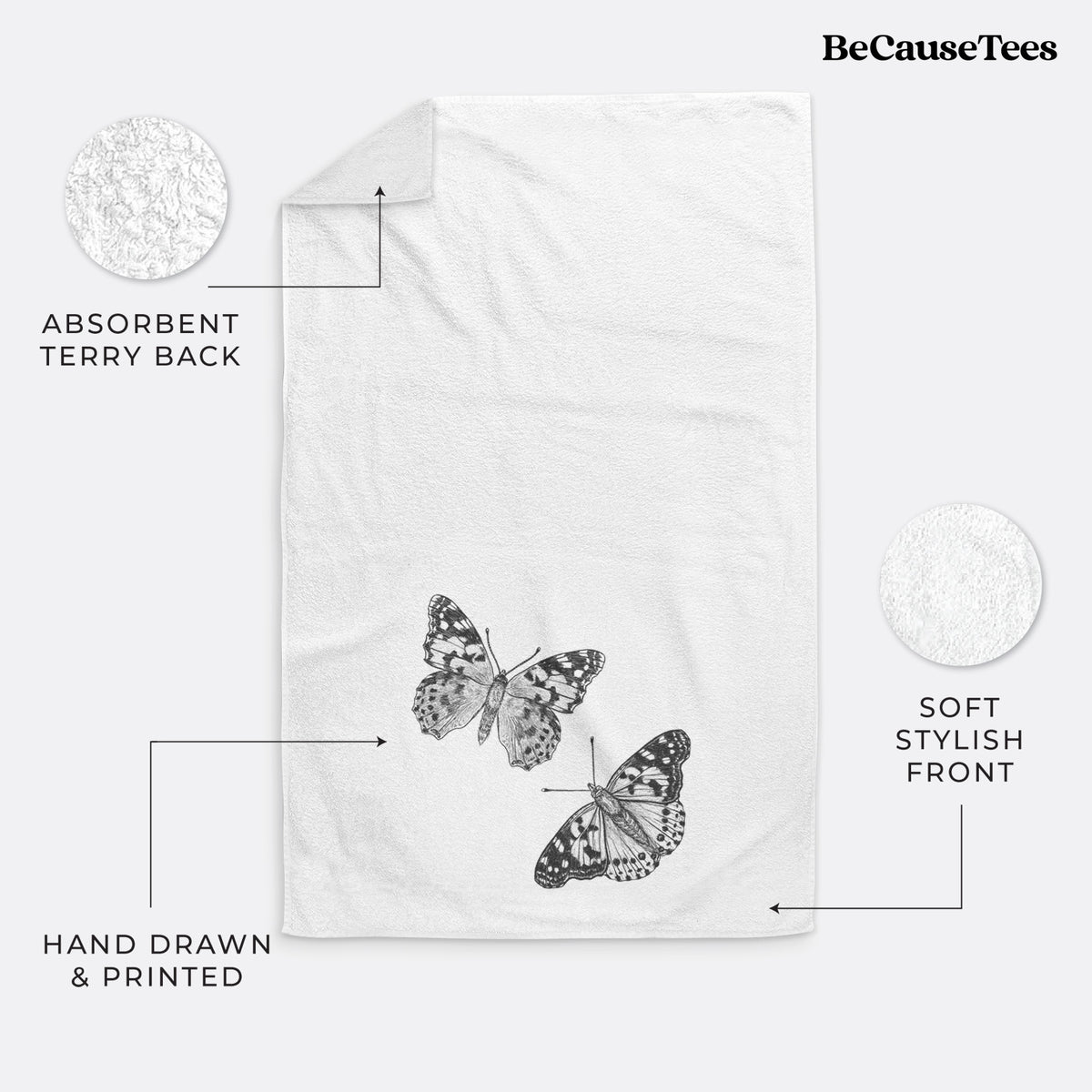 White hand towel printed with a detailed black ink illustration of two painted lady butterflies.