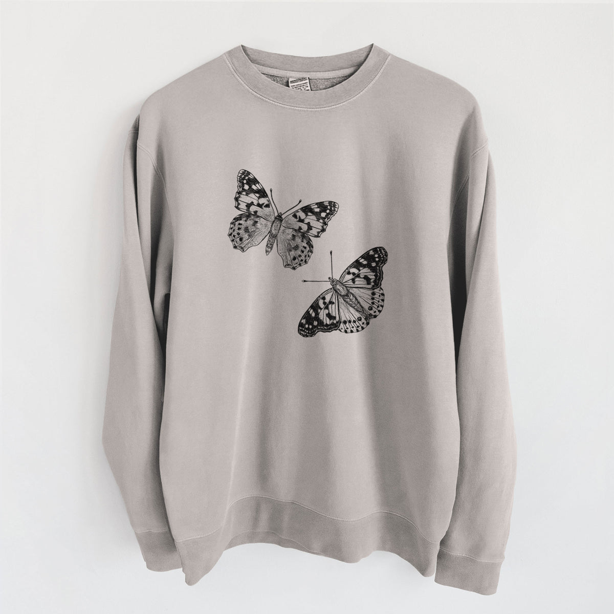 Cement grey pigment dyed crewneck sweatshirt laid flat, printed with a detailed black ink illustration of two painted lady butterflies.