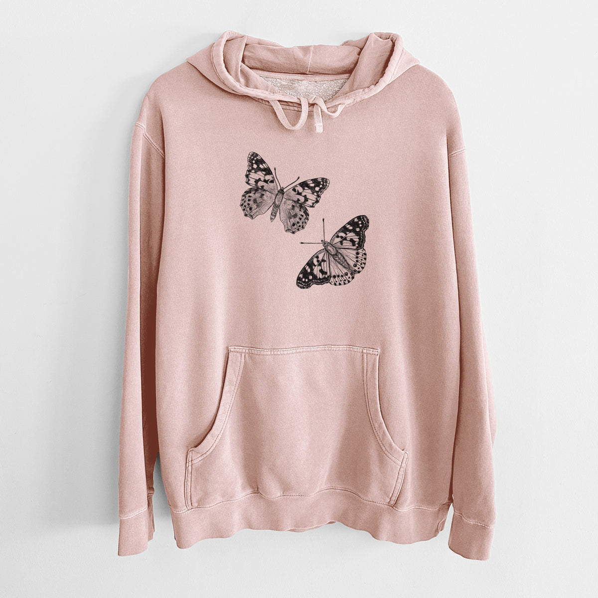 Dusty pink pigment dyed hoodie laid flat, printed with a detailed black ink illustration of two painted lady butterflies.