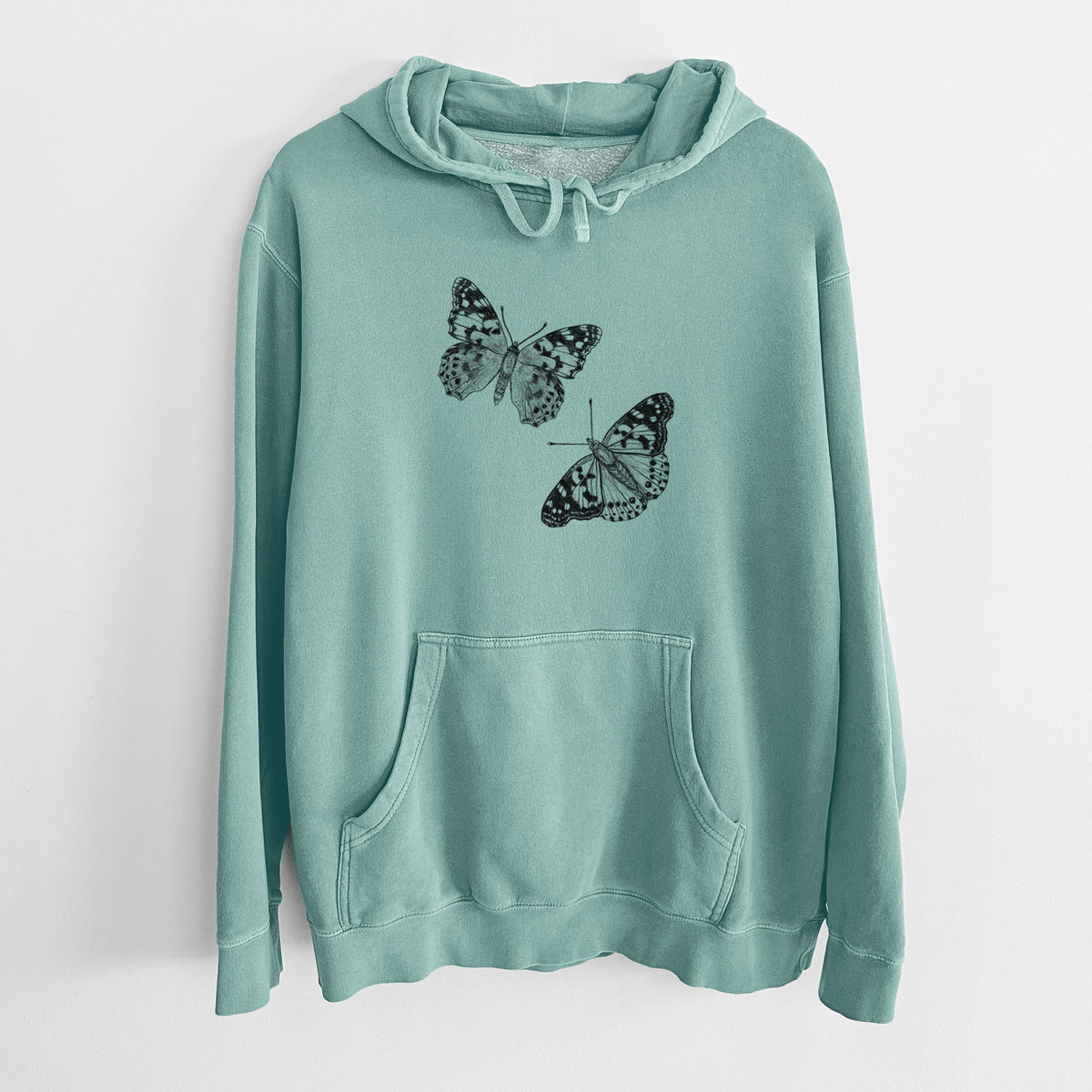 Mint green pigment dyed hoodie laid flat, printed with a detailed black ink illustration of two painted lady butterflies.