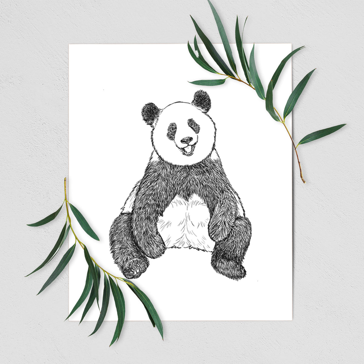 Art print of a black ink illustration of a giant panda sitting and facing forward, shown with eucalyptus leaves.
