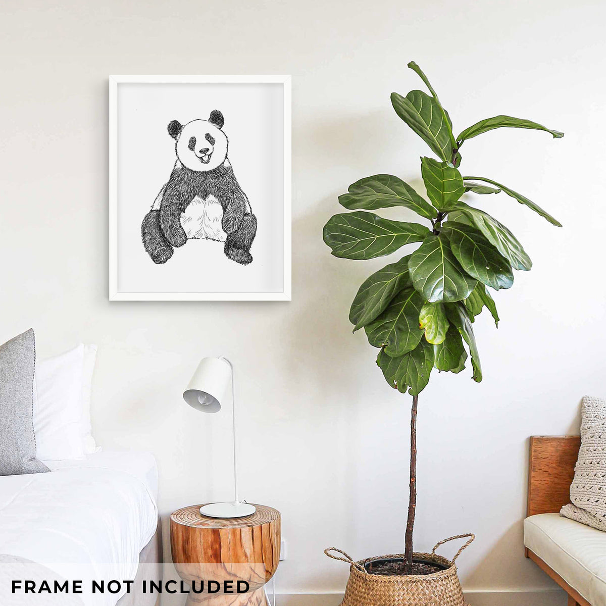 Art print of a black ink illustration of a giant panda sitting and facing forward, shown framed on a living room wall beside a potted plant. Frame not included.