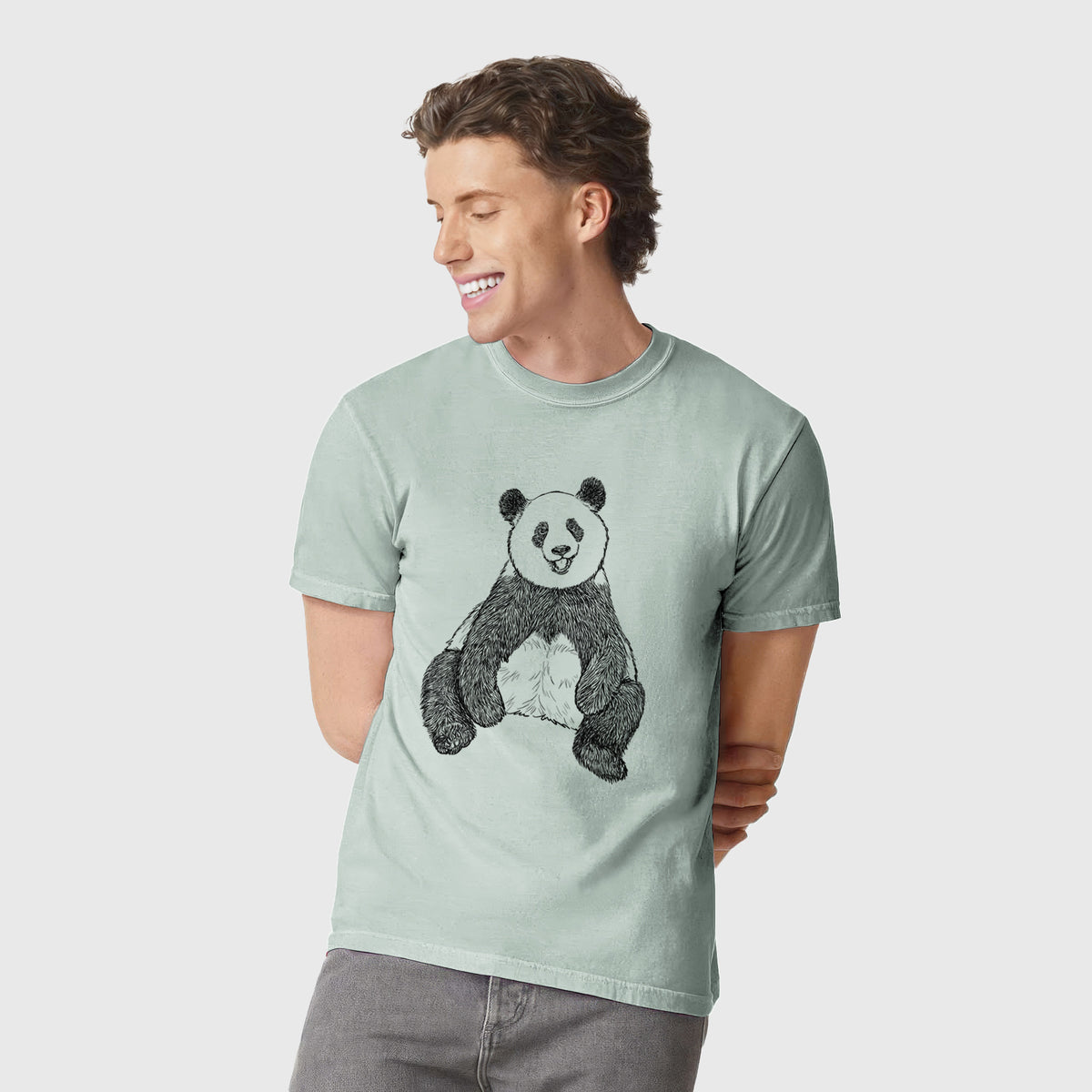 Man wearing a Comfort Colors t-shirt printed with a black ink illustration of a giant panda sitting and facing forward.