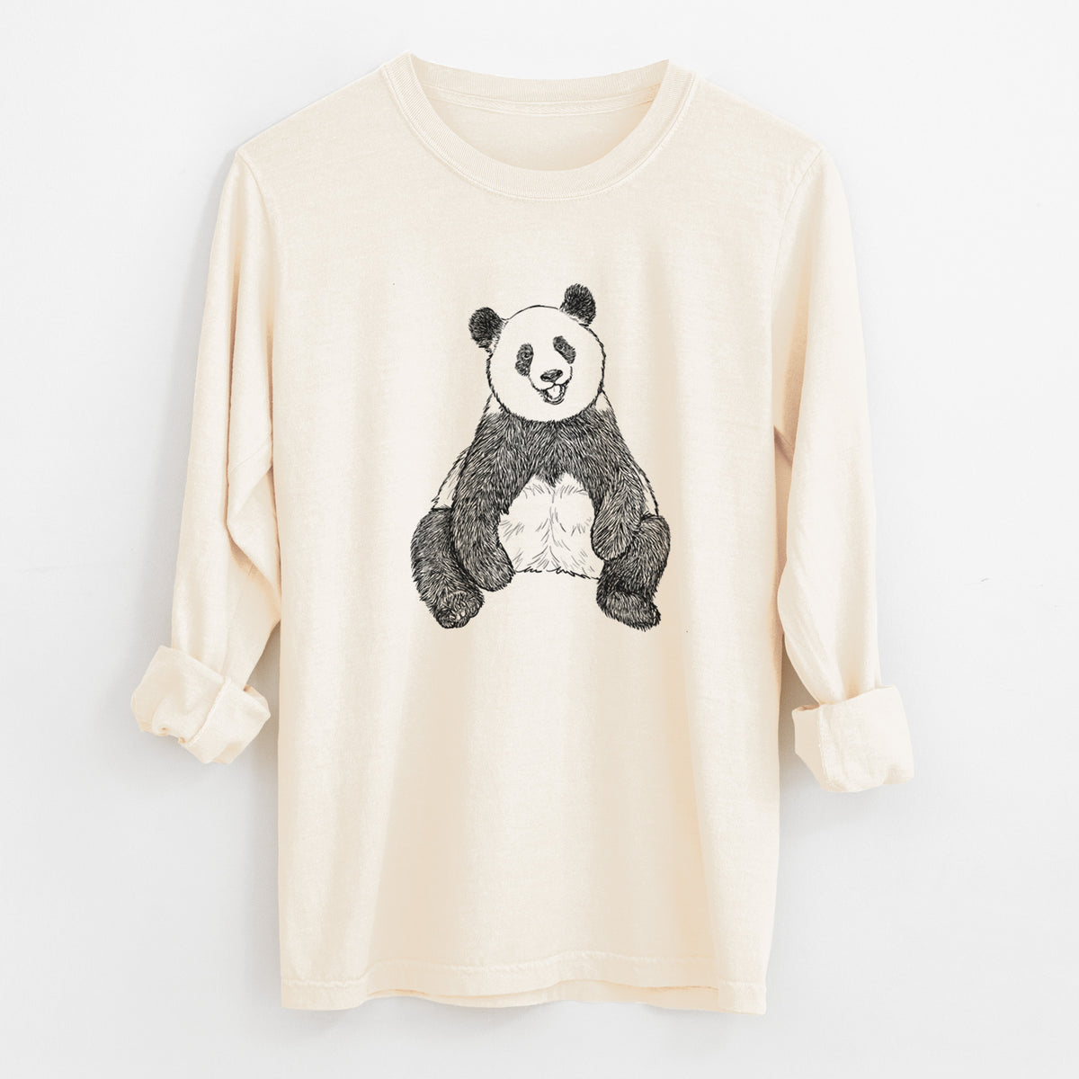 Ivory Comfort Colors long sleeve shirt laid flat with the cuffs rolled, printed with a black ink illustration of a giant panda sitting and facing forward.
