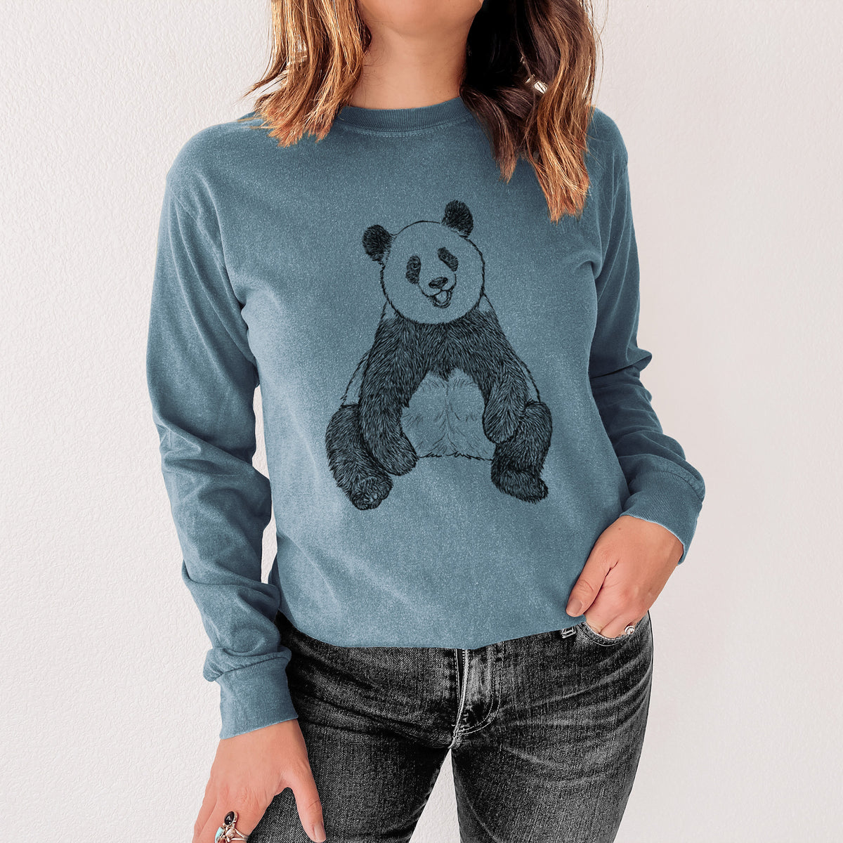 Steel blue Comfort Colors long sleeve shirt printed with a black ink illustration of a giant panda sitting and facing forward, shown in a lifestyle photo.