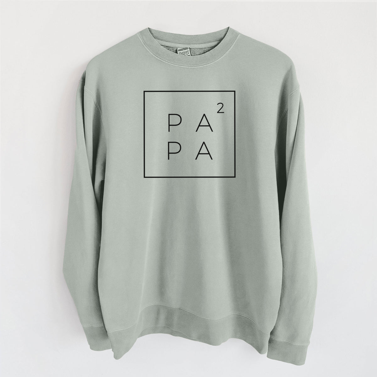Sage green pigment dyed crewneck sweatshirt laid flat, printed with the word PAPA stacked inside a square outline with a small squared symbol, for a papa of two.