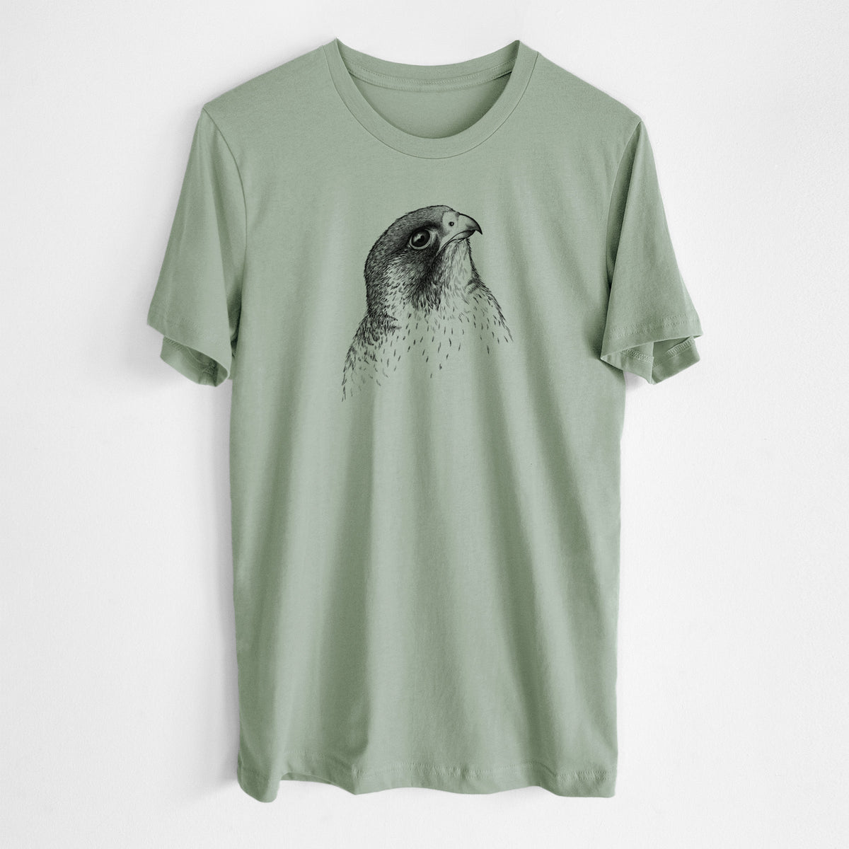 Sage green lightweight cotton t-shirt laid flat, printed with a detailed black ink portrait of a peregrine falcon's head.
