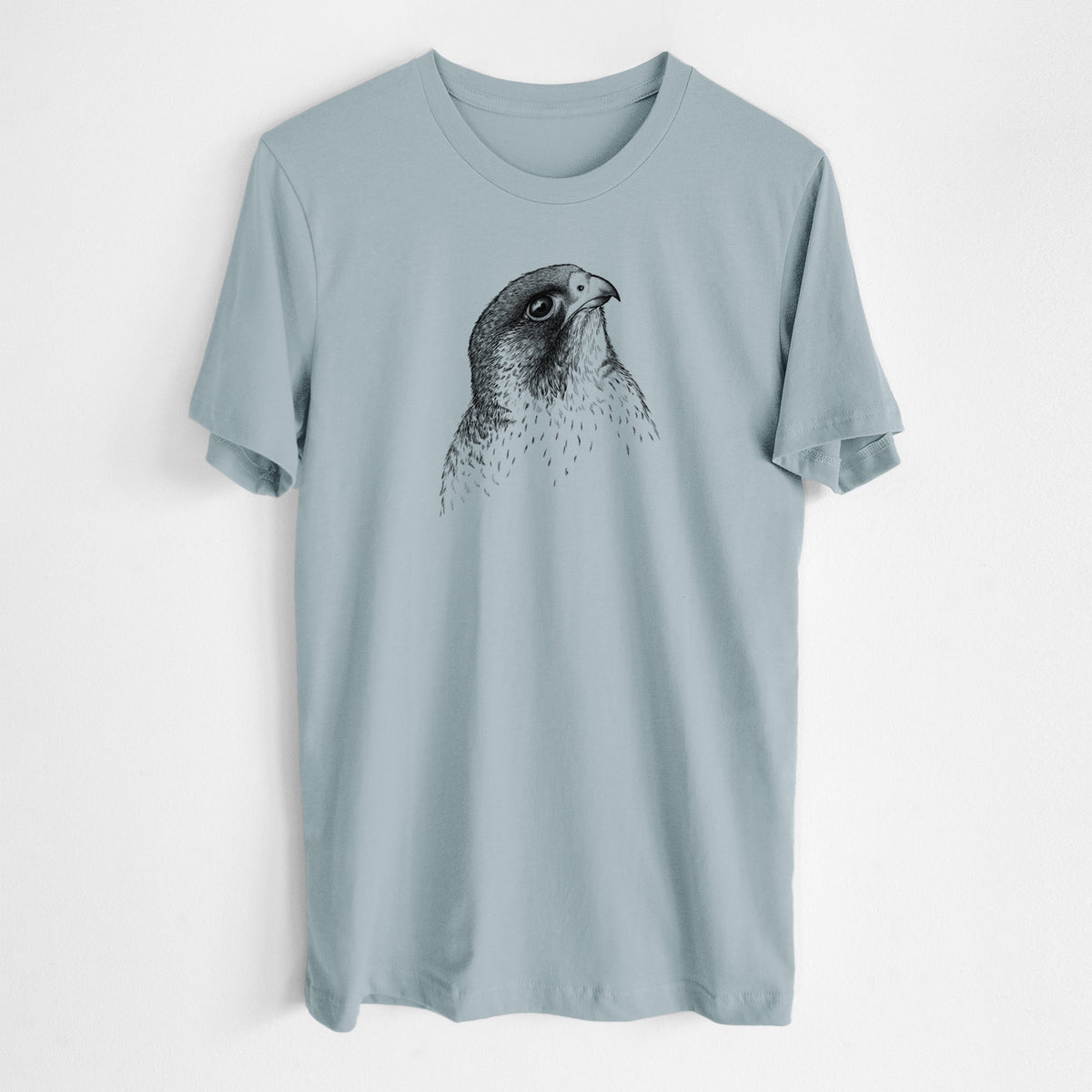 Vintage denim lightweight cotton t-shirt laid flat, printed with a detailed black ink portrait of a peregrine falcon's head.