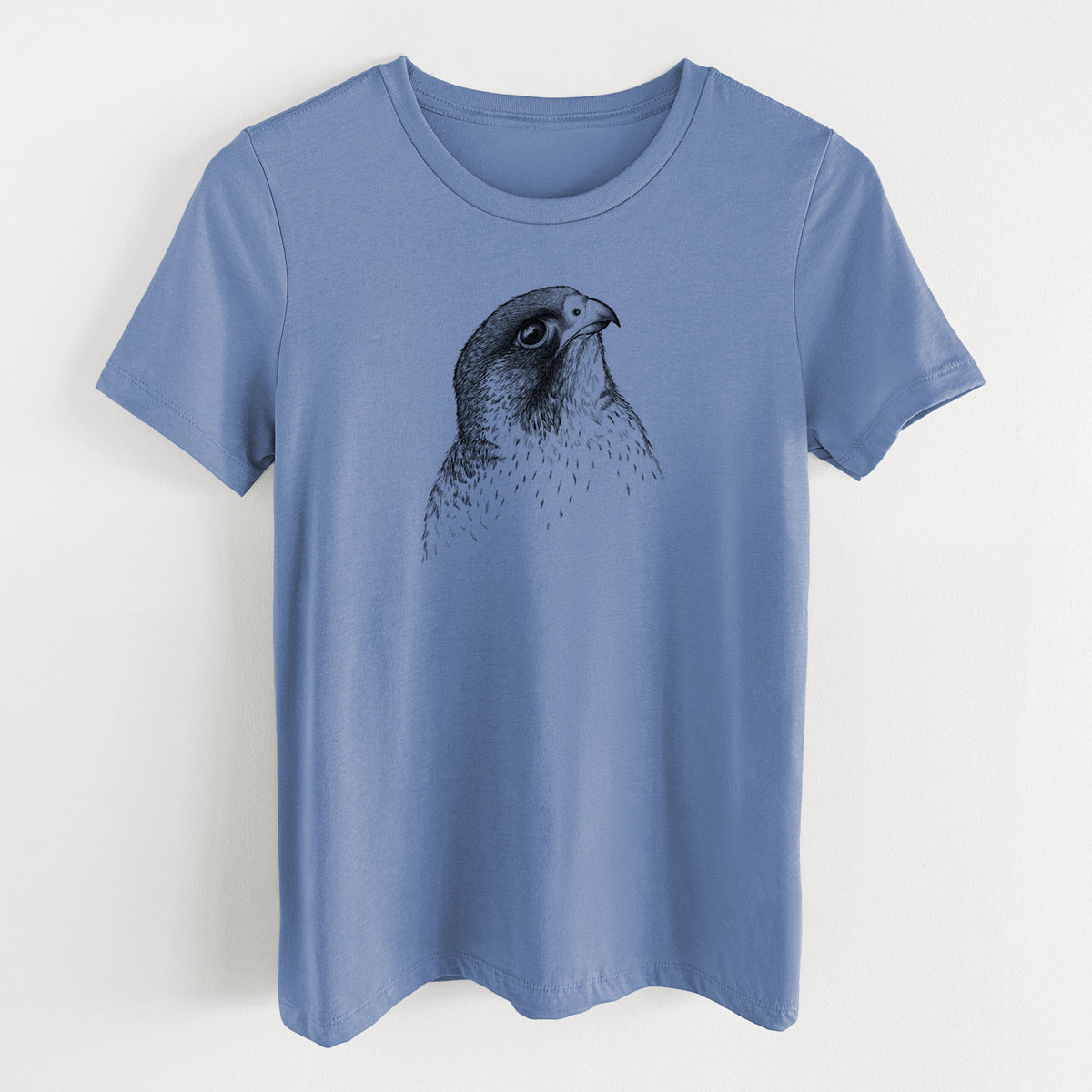 Blue bell women's relaxed fit cotton t-shirt laid flat, printed with a detailed black ink portrait of a peregrine falcon's head.