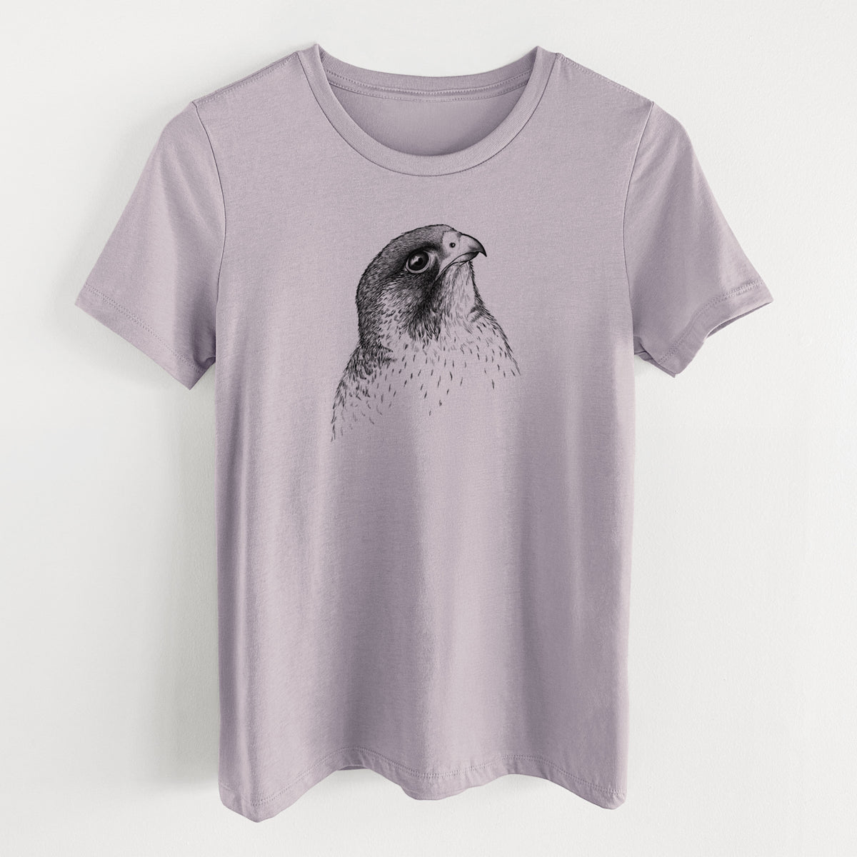 Light violet women's relaxed fit cotton t-shirt laid flat, printed with a detailed black ink portrait of a peregrine falcon's head.