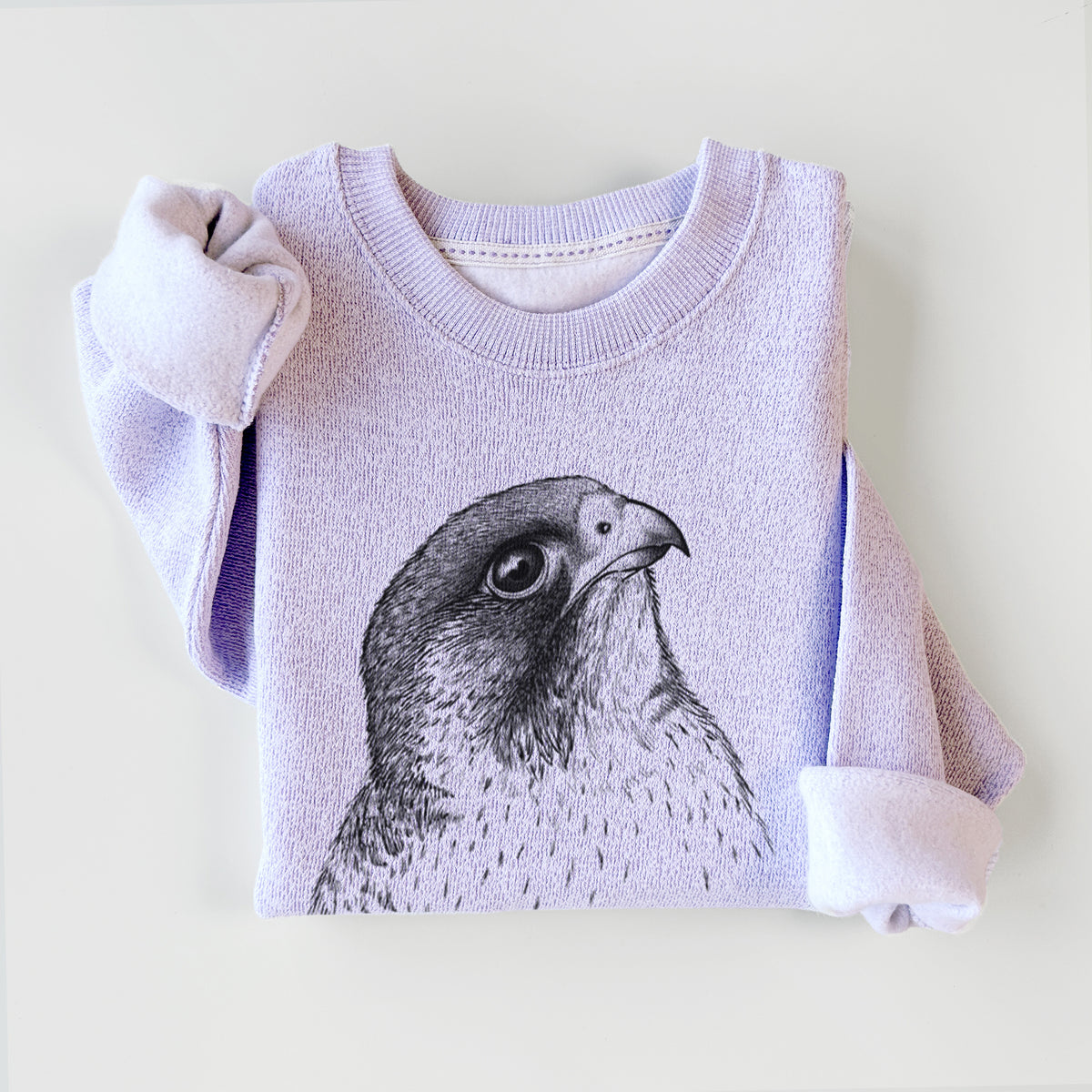 Ice purple knit sweatshirt printed with a detailed black ink portrait of a peregrine falcon's head, styled flat.