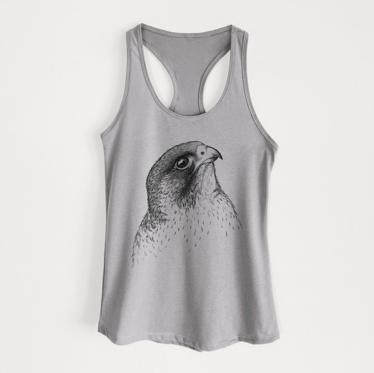 Heather grey women's racerback tank top laid flat, printed with a detailed black ink portrait of a peregrine falcon's head.