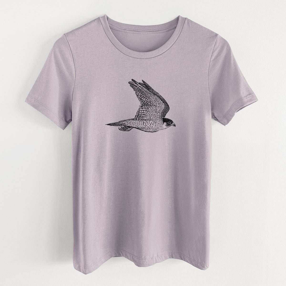 Light violet women's relaxed fit cotton t-shirt laid flat, printed with a detailed black ink illustration of a peregrine falcon in flight.
