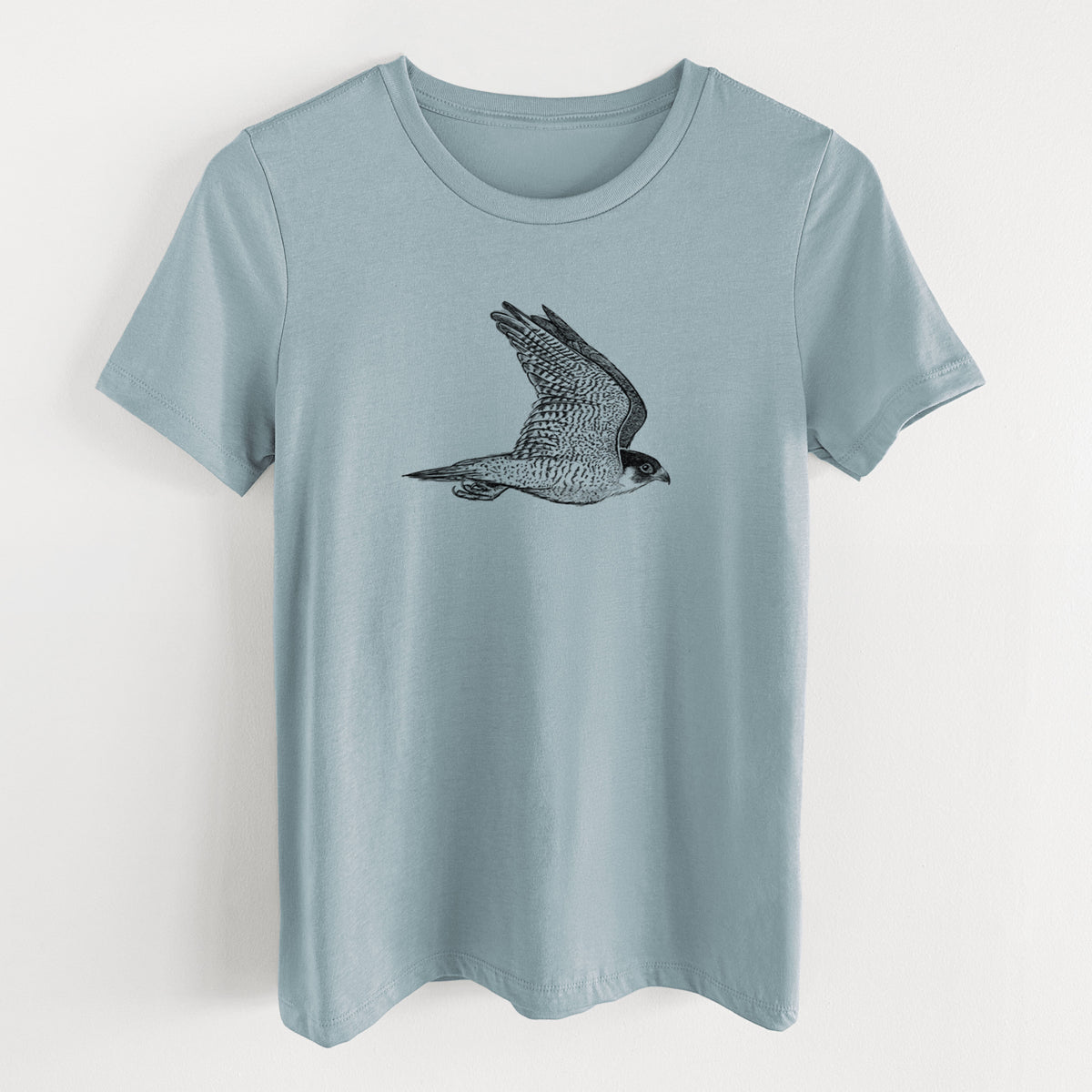 Vintage denim women's relaxed fit cotton t-shirt laid flat, printed with a detailed black ink illustration of a peregrine falcon in flight.