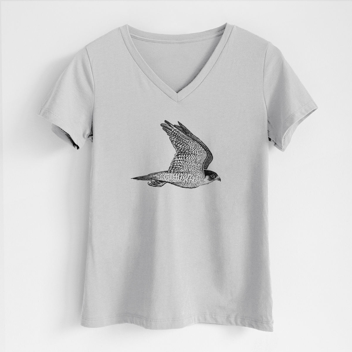 Lunar grey women's relaxed fit cotton V-neck t-shirt laid flat, printed with a detailed black ink illustration of a peregrine falcon in flight.