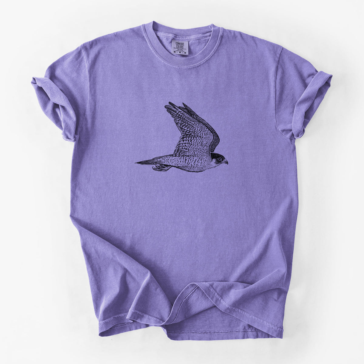 Violet purple Comfort Colors t-shirt laid flat, printed with a detailed black ink illustration of a peregrine falcon in flight.