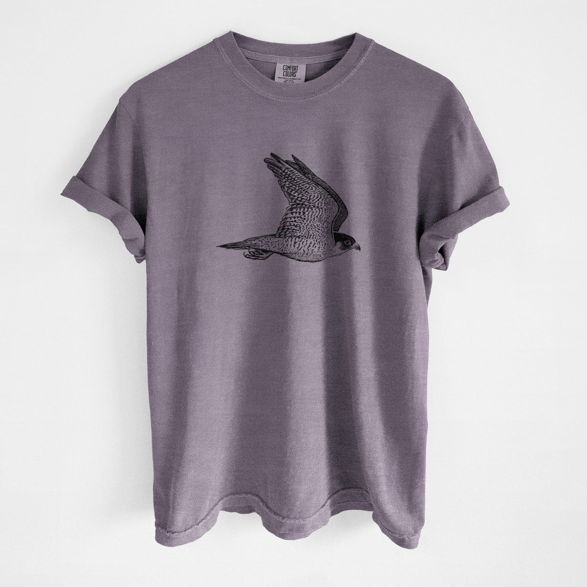 Wine red Comfort Colors t-shirt laid flat, printed with a detailed black ink illustration of a peregrine falcon in flight.