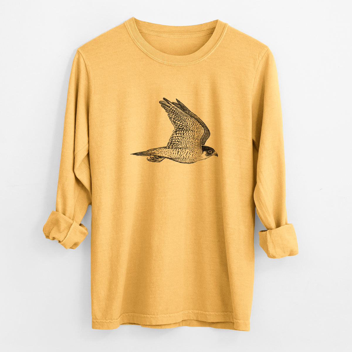 Golden wheat yellow Comfort Colors long sleeve shirt laid flat with the cuffs rolled, printed with a detailed black ink illustration of a peregrine falcon in flight.