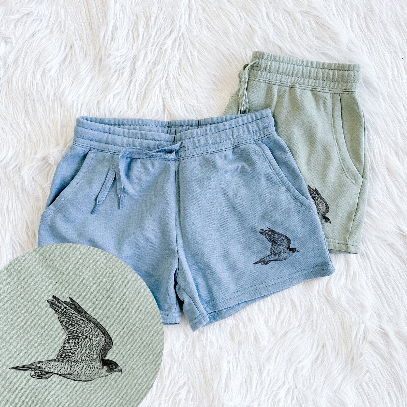 Two pairs of Cali Wave shorts in different colors printed with a detailed black ink illustration of a peregrine falcon in flight, with a close-up of the print.