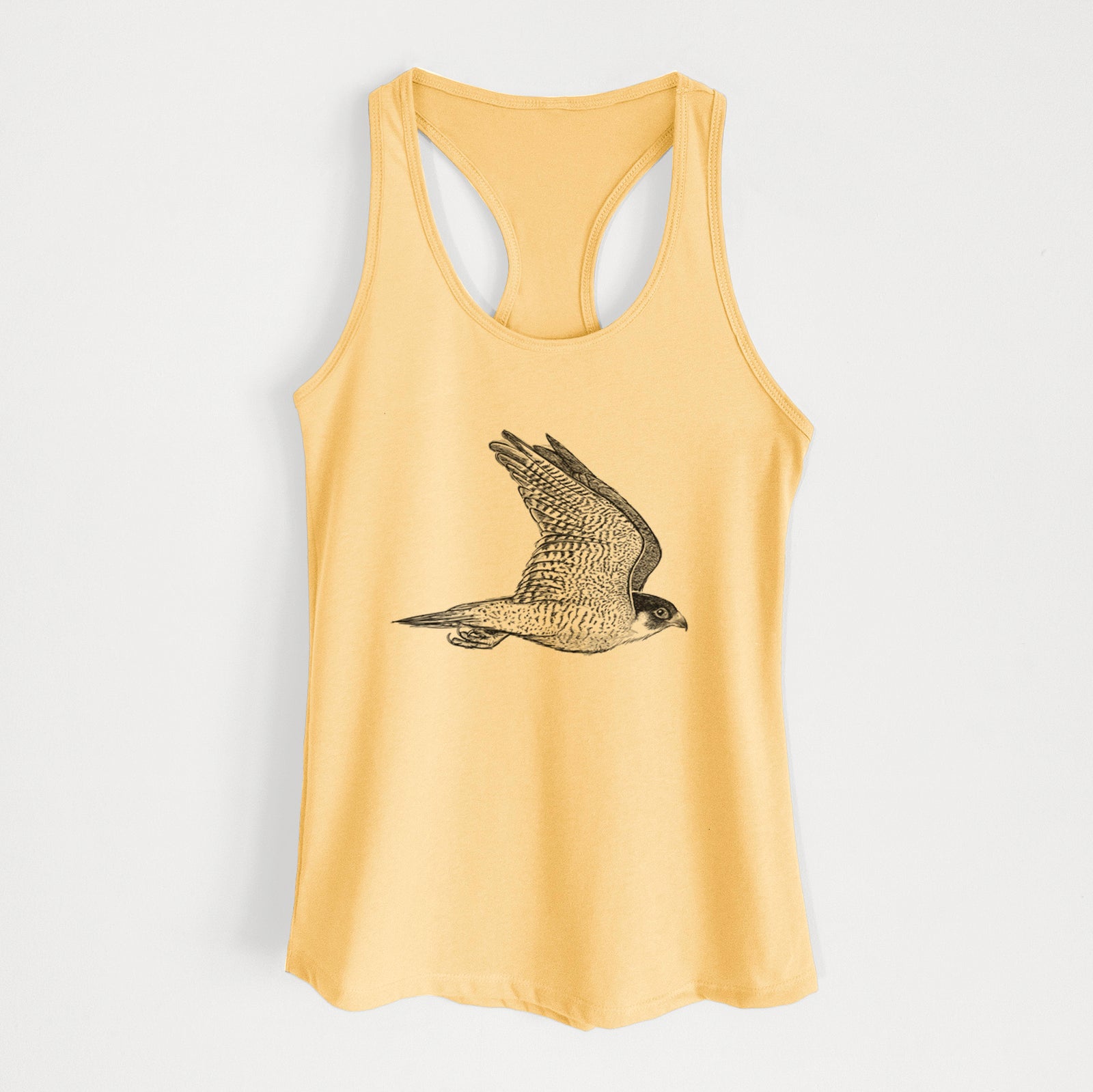 Banana cream women's racerback tank top laid flat, printed with a detailed black ink illustration of a peregrine falcon in flight.