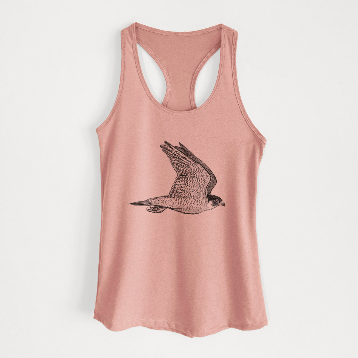 Desert pink women's racerback tank top laid flat, printed with a detailed black ink illustration of a peregrine falcon in flight.