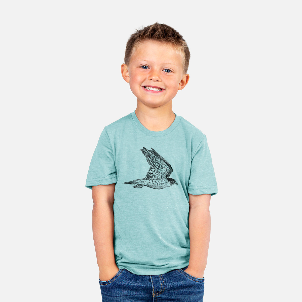 Smiling boy wearing a youth t-shirt printed with a detailed black ink illustration of a peregrine falcon in flight.