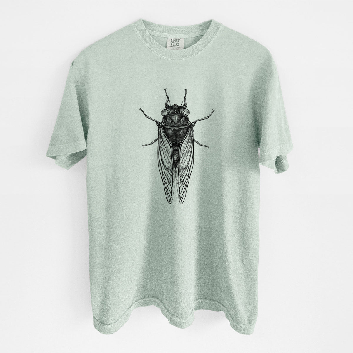 Bay green Comfort Colors t-shirt laid flat, printed with a detailed black ink illustration of a periodical cicada with its wings folded, seen from above.