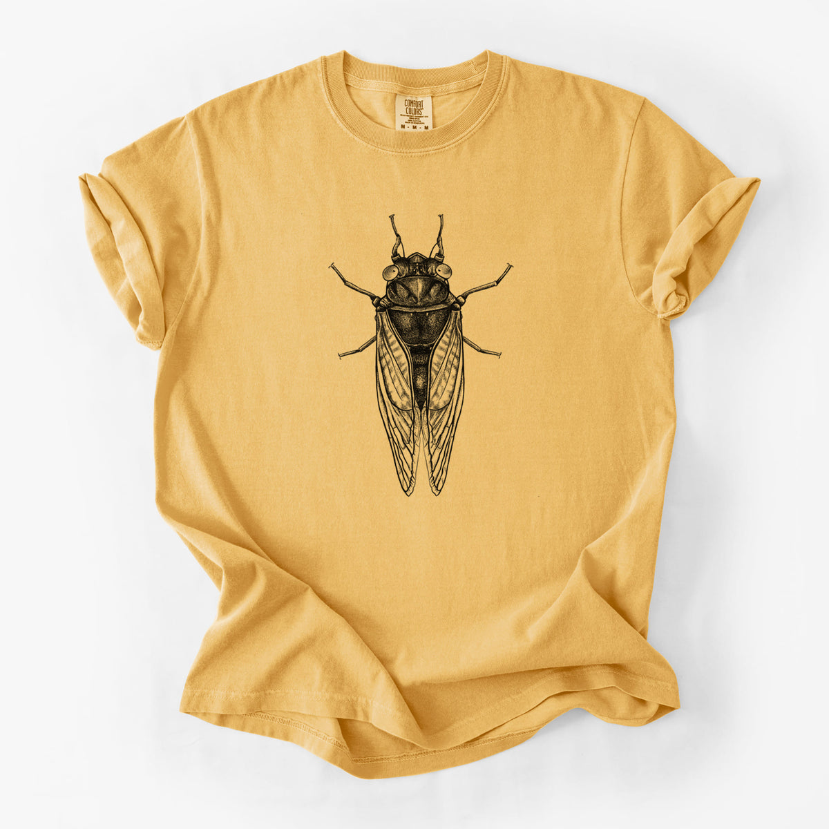 Golden wheat yellow Comfort Colors t-shirt laid flat, printed with a detailed black ink illustration of a periodical cicada with its wings folded, seen from above.