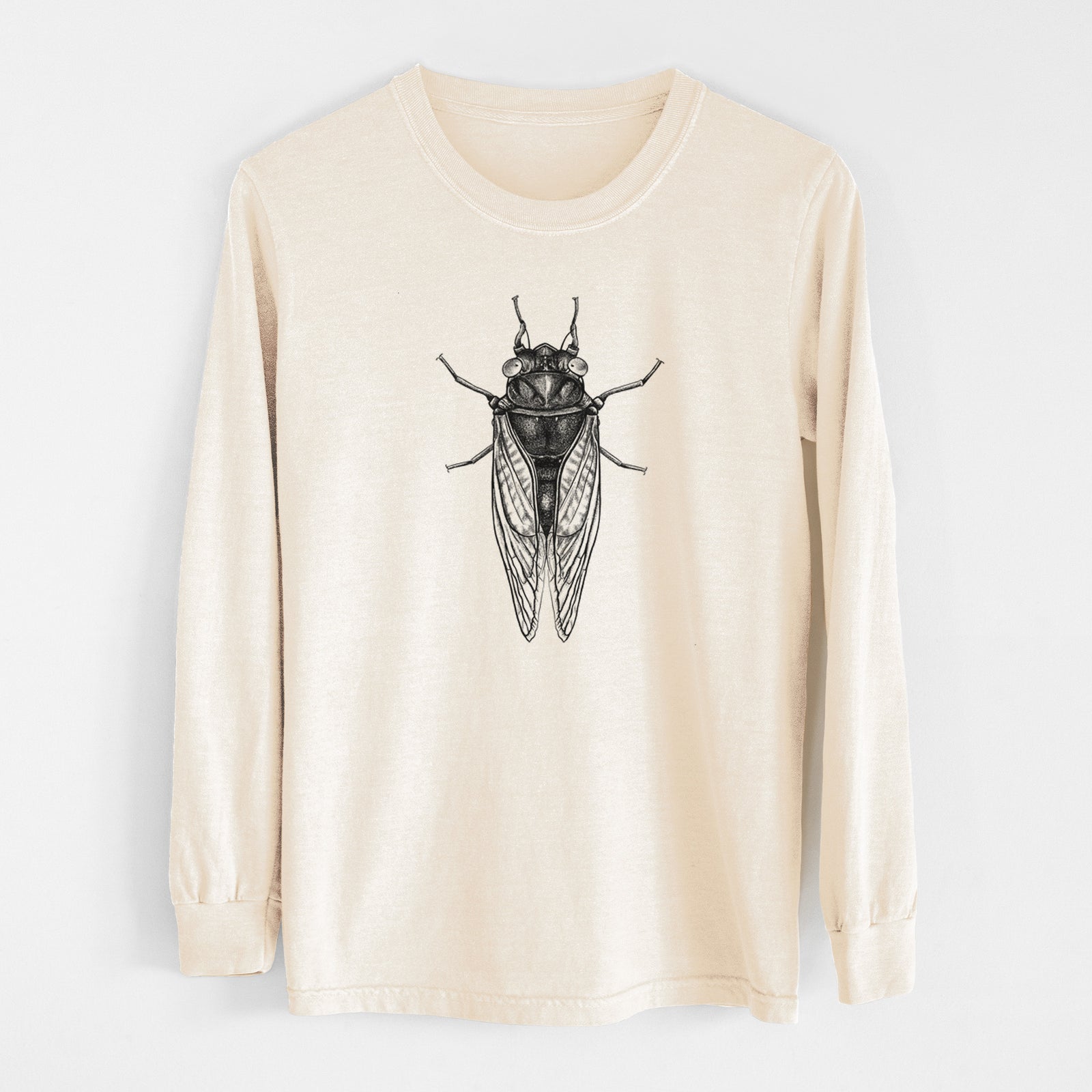 Ivory Comfort Colors long sleeve shirt laid flat, printed with a detailed black ink illustration of a periodical cicada with its wings folded, seen from above.