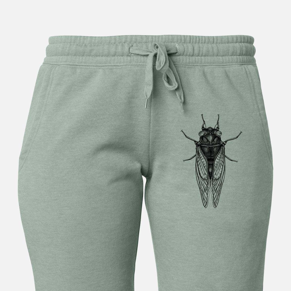 Front of sage green Cali Wave sweatpants, printed with a detailed black ink illustration of a periodical cicada with its wings folded, seen from above on the leg.