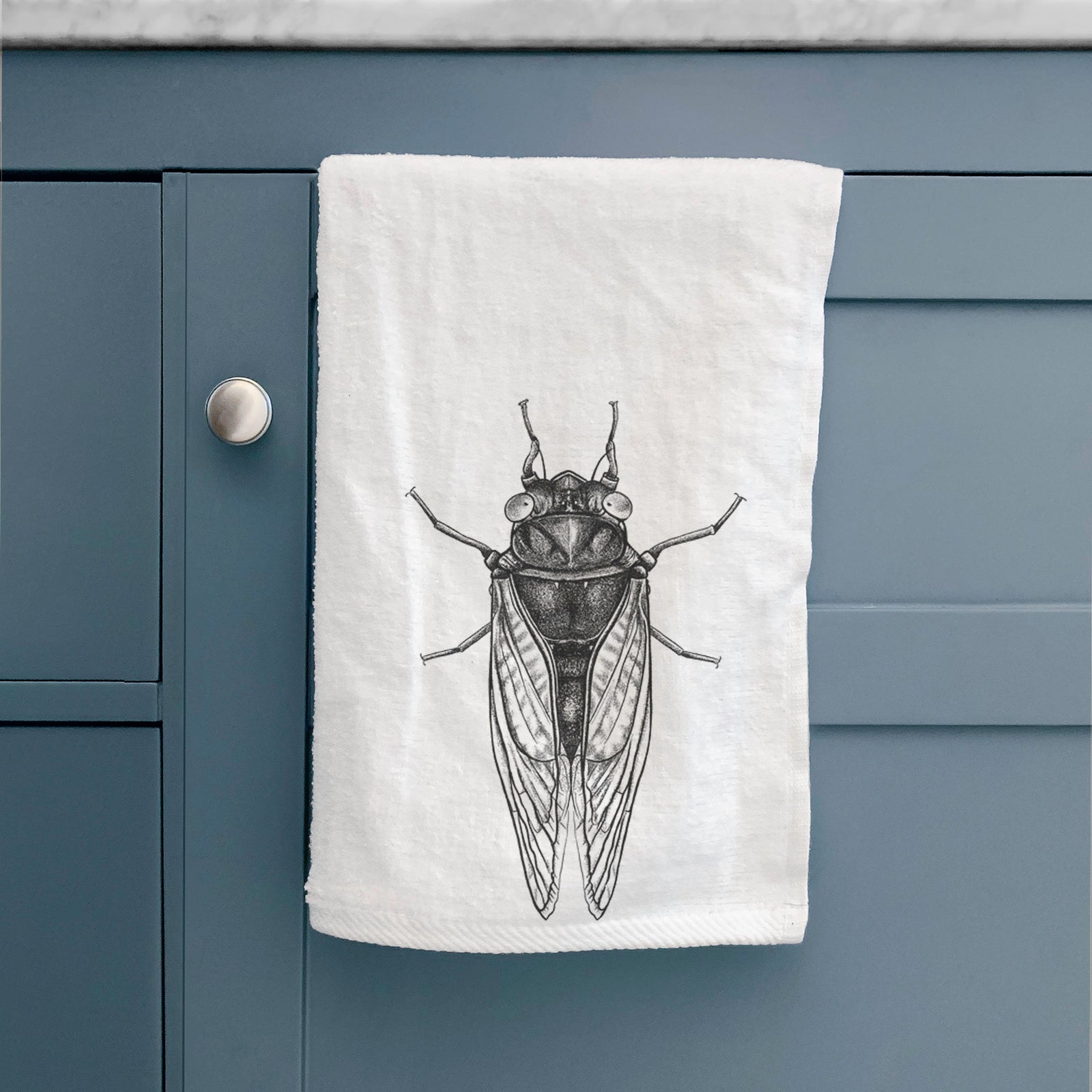 White hand towel printed with a detailed black ink illustration of a periodical cicada with its wings folded, seen from above.