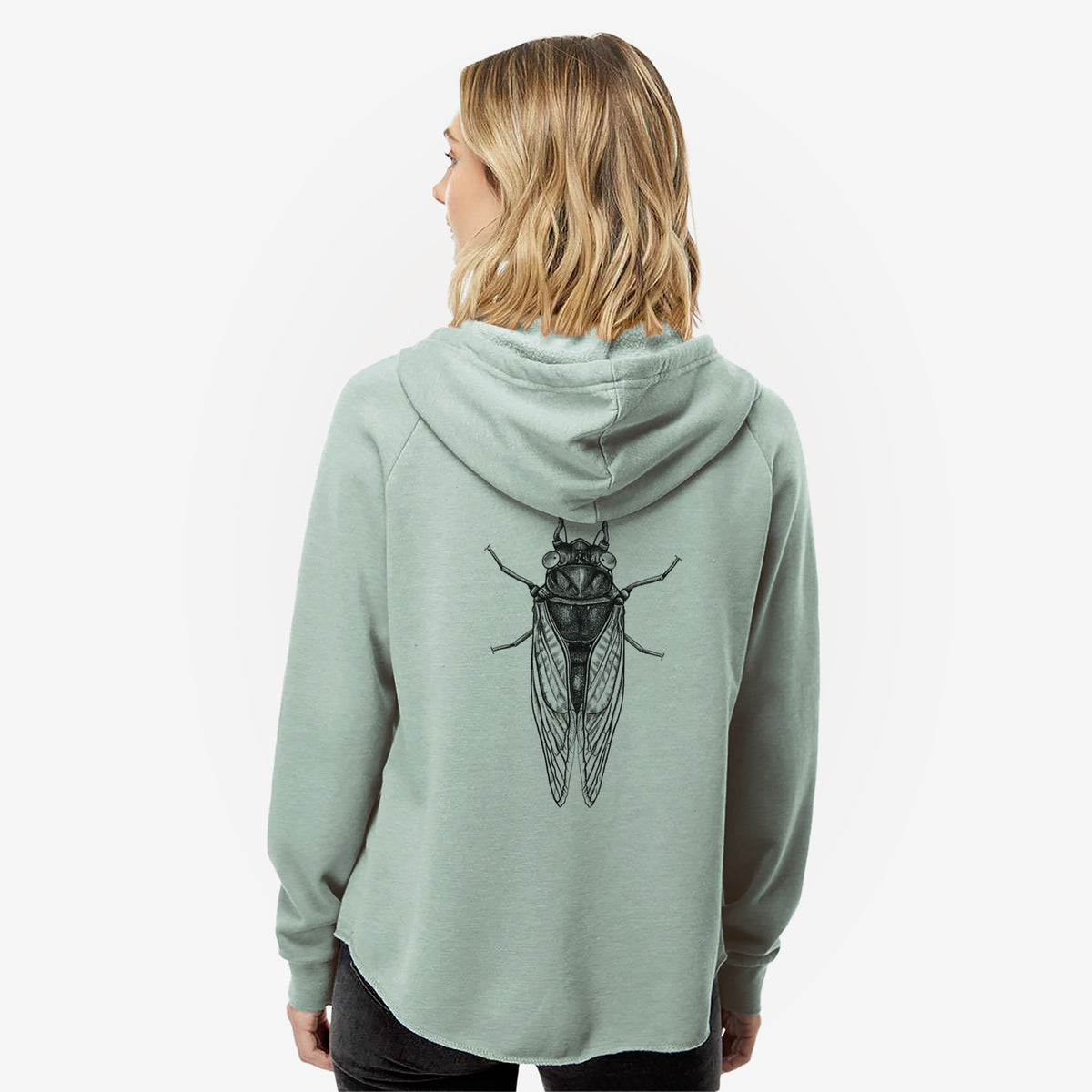 Woman wearing a sage green women's Cali Wave zip-up sweatshirt printed with a detailed black ink illustration of a periodical cicada with its wings folded, seen from above, seen from behind.