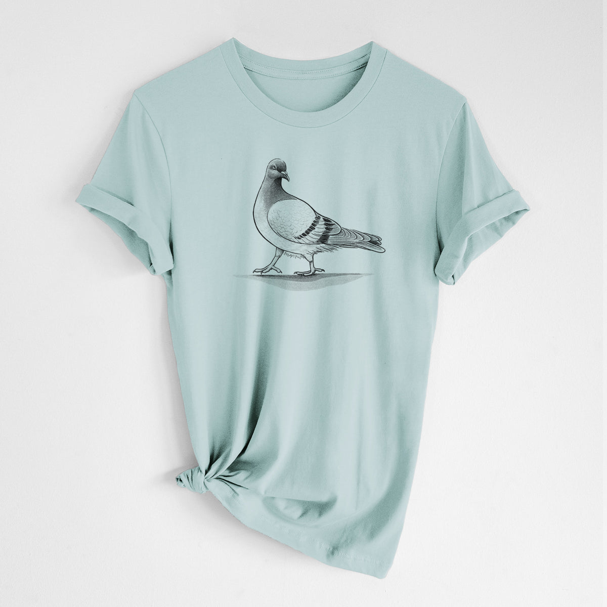 Dusty blue lightweight cotton t-shirt laid flat with the sleeves rolled, printed with a black ink illustration of a pigeon standing.