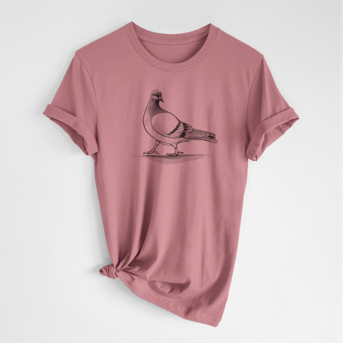 Mauve pink lightweight cotton t-shirt laid flat with the sleeves rolled, printed with a black ink illustration of a pigeon standing.