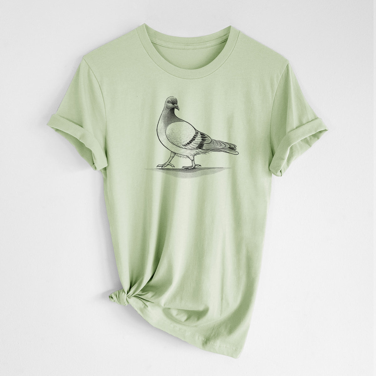 Spring green lightweight cotton t-shirt laid flat with the sleeves rolled, printed with a black ink illustration of a pigeon standing.