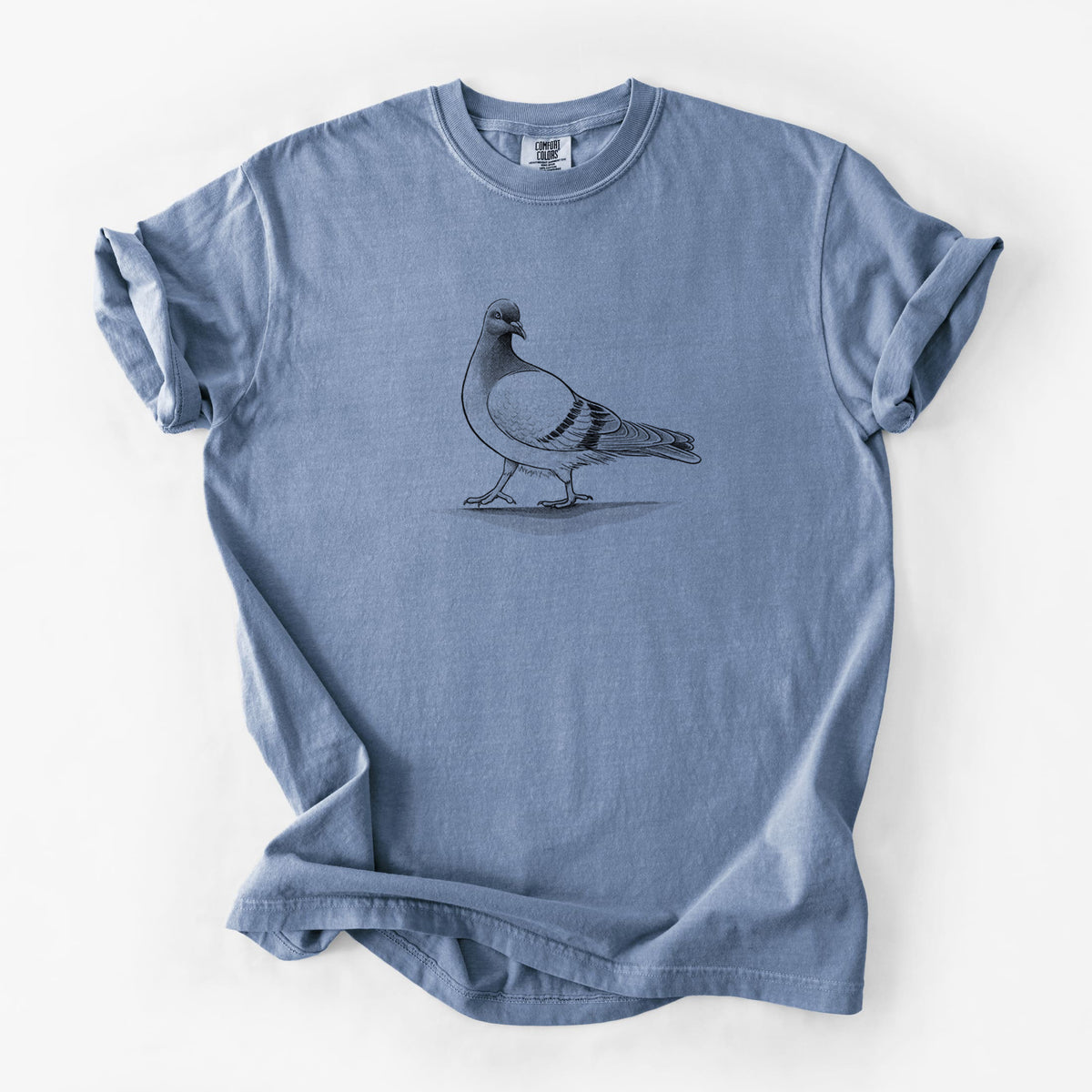 Blue jean Comfort Colors t-shirt laid flat, printed with a black ink illustration of a pigeon standing.